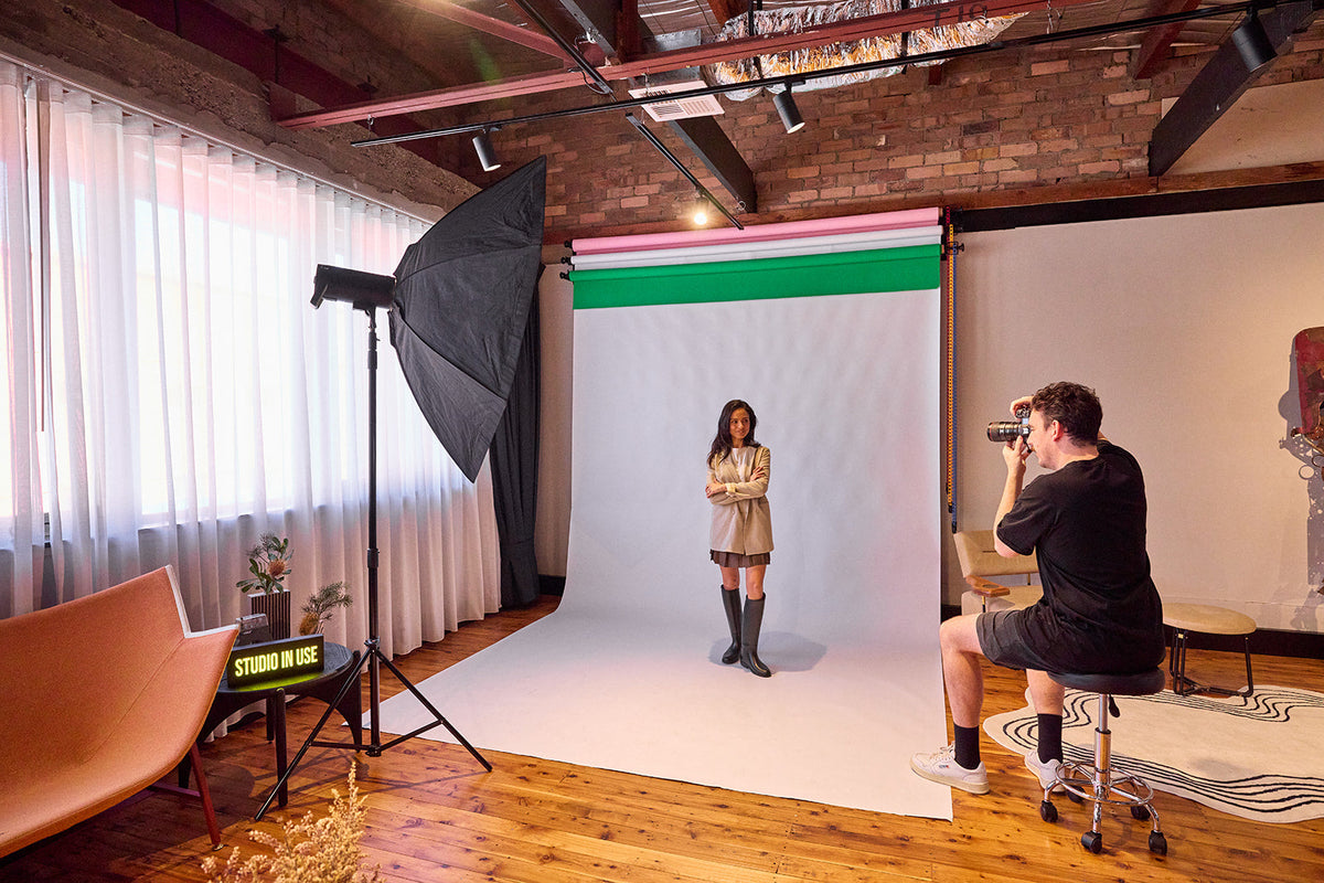 Photographer shooting a model against the white cyclorama wall at the Goodspace Kingsgrove photography studio