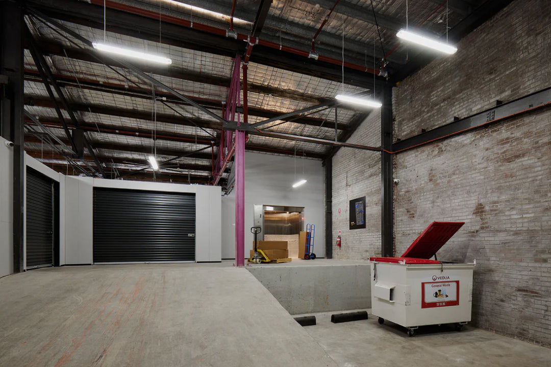 Warehouse bay with black roller doors and a loading dock inside Goodspace Kingsgrove